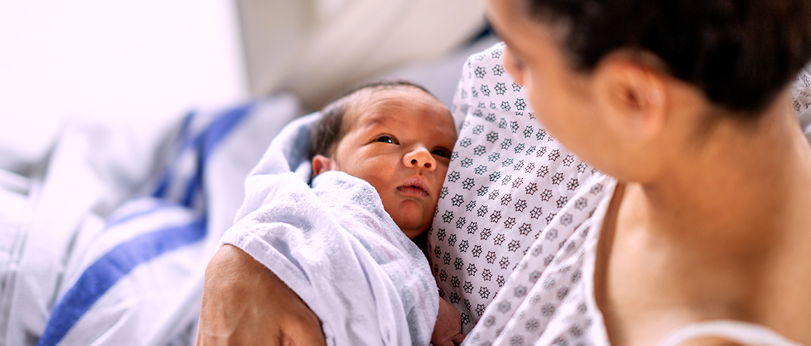 Woman holds newborn after giving birth